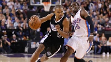 Dec 16, 2014; Sacramento, CA, USA; Sacramento Kings guard Ramon Sessions (9) drives in against Oklahoma City Thunder guard Reggie Jackson (15) during the fourth quarter at Sleep Train Arena. The Oklahoma City Thunder defeated the Sacramento Kings 104-92. Mandatory Credit: Kelley L Cox-USA TODAY Sports