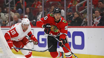 Dylan Sikura #95 of the Chicago Blackhawks controls the puck in front of Chris Terry #15 of the Detroit Red Wings. (Photo by Jonathan Daniel/Getty Images)