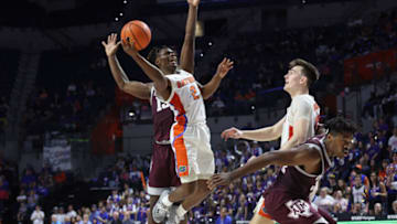 Jan 4, 2023; Gainesville, Florida, USA; Florida Gators guard Trey Bonham (2) drives to the basket as Texas A&M Aggies forward Henry Coleman III (15) defends during the second half at Exactech Arena at the Stephen C. O'Connell Center. Mandatory Credit: Kim Klement-USA TODAY Sports