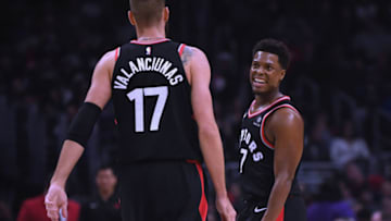 Kyle Lowry #7 of the Toronto Raptors celebrates a 103-74 lead with Jonas Valanciunas (Photo by Harry How/Getty Images)