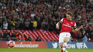 Arsenal's Swedish midfielder Kim Kallstrom scores his penalty during the penalty shootout during the English FA Cup Semi-final match between Wigan Athletic and Arsenal at Wembley Stadium in London on April 12, 2014. Arsenal beat holders Wigan Athletic 4-2 on penalties to win a dramatic FA Cup semi-final at Wembley after the teams were level at 1-1 after extra-time. AFP PHOTO/IAN KINGTON- NOT FOR MARKETING OR ADVERTISING USE / RESTRICTED TO EDITORIAL USE (Photo credit should read IAN KINGTON/AFP via Getty Images)