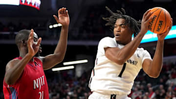 Cincinnati Bearcats center Kalu Ezikpe pulls down a rebounds at Fifth Third Arena. The Enquirer.