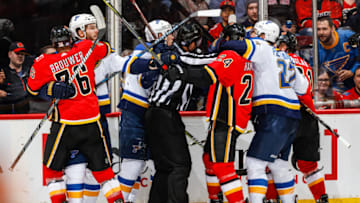 CALGARY, AB - NOVEMBER 13: A ref tries to stop a fight in an NHL game of the Calgary Flames against the St. Louis Blues at the Scotiabank Saddledome on November 13, 2017 in Calgary, Alberta, Canada. (Photo by Gerry Thomas/NHLI via Getty Images)