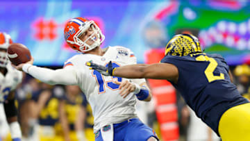 ATLANTA, GEORGIA - DECEMBER 29: Feleipe Franks #13 of the Florida Gators throws under pressure from Carlo Kemp #2 of the Michigan Wolverines in the first quarter during the Chick-fil-A Peach Bowl at Mercedes-Benz Stadium on December 29, 2018 in Atlanta, Georgia. (Photo by Mike Zarrilli/Getty Images)