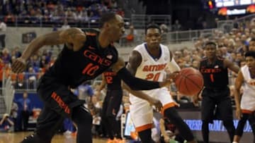 Nov 17, 2014; Gainesville, FL, USA; Miami Hurricanes guard Sheldon McClellan (10) and Florida Gators guard Michael Frazier II (20) go after the ball during the first half at Stephen C. O