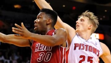 Dec 3, 2013; Miami, FL, USA; Miami Heat point guard Norris Cole (30) shoots the ball as Detroit Pistons small forward Kyle Singler (25) defends during the second half at American Airlines Arena. Mandatory Credit: Steve Mitchell-USA TODAY Sports