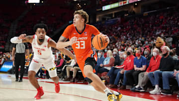 COLLEGE PARK, MARYLAND - JANUARY 21: Coleman Hawkins #33 of the Illinois Fighting Illini dribbles by Eric Ayala #5 of the Maryland Terrapins in the first half during a college basketball game against the Maryland Terrapins at the XFinity Center on January 21, 2022 in College Park, Maryland. (Photo by Mitchell Layton/Getty Images)