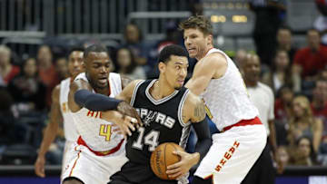Dec 12, 2015; Atlanta, GA, USA; San Antonio Spurs guard Danny Green (14) gets by the defense of Atlanta Hawks forward Paul Millsap (4) and guard Kyle Korver (26) in the first quarter of their game at Philips Arena. Mandatory Credit: Jason Getz-USA TODAY Sports