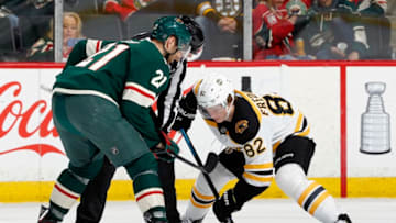 ST. PAUL, MN - APRIL 04: Eric Fehr #21 of the Minnesota Wild and Trent Frederic #82 of the Boston Bruins face-off during a game at Xcel Energy Center on April 4, 2019 in St. Paul, Minnesota.(Photo by Bruce Kluckhohn/NHLI via Getty Images)