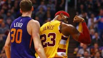 Dec 28, 2015; Phoenix, AZ, USA; Cleveland Cavaliers forward LeBron James flexes his arm muscle after making a shot and receiving a foul call against Phoenix Suns forward Jon Leuer (30) in the first quarter at Talking Stick Resort Arena. Mandatory Credit: Mark J. Rebilas-USA TODAY Sports
