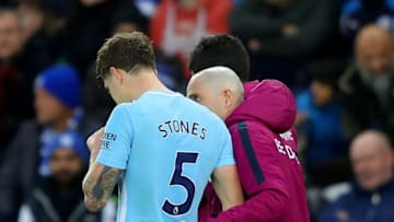LEICESTER, ENGLAND - NOVEMBER 18: John Stones of Manchester City leaves the pitch with medical staffs during the Premier League match between Leicester City and Manchester City at The King Power Stadium on November 18, 2017 in Leicester, England. (Photo by Richard Heathcote/Getty Images)