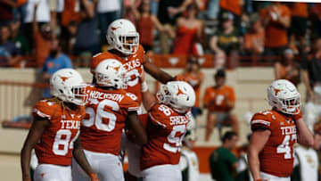 AUSTIN, TX - OCTOBER 13: Collin Johnson #9 of the Texas Longhorns is congratulated by teammates after a first half touchdown against the Baylor Bears at Darrell K Royal-Texas Memorial Stadium on October 13, 2018 in Austin, Texas. (Photo by Tim Warner/Getty Images)