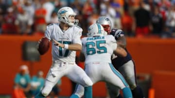 Dec 15, 2013; Miami Gardens, FL, USA: Miami Dolphins quarterback Ryan Tannehill (17) prepares to throw the ball as guard Sam Brenner (65) blocks New England Patriots defensive tackle Sealver Siliga (71) in the second half at Sun Life Stadium. The Dolphins won 24-20. Mandatory Credit: Robert Mayer-USA TODAY Sports