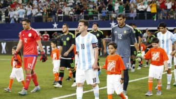 Sep 8, 2015; Arlington, TX, USA; Argentina forward Lionel Messi (10) is lead unto the field by a young soccer player prior to the game against Mexico at AT&T Stadium. Mandatory Credit: Matthew Emmons-USA TODAY Sports