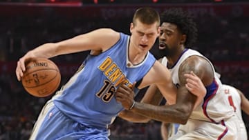 Mar 27, 2016; Los Angeles, CA, USA; Denver Nuggets center Nikola Jokic (15) is defended by Los Angeles Clippers center DeAndre Jordan (6) during an NBA game at Staples Center. Mandatory Credit: Kirby Lee-USA TODAY Sports