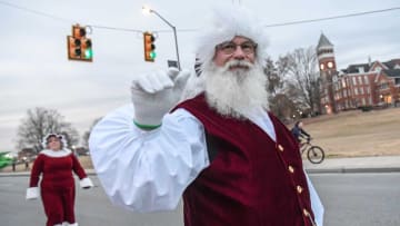 Santa Claus and Mrs. Claus walk by Tillman Hall along State Highway 93 and visit people an hour before the start of The Magic of Christmas 28th Annual Clemson Christmas Parade, from College Avenue to Strode Circle in Clemson Tuesday, December 7, 2021.Clemson Christmas Parade