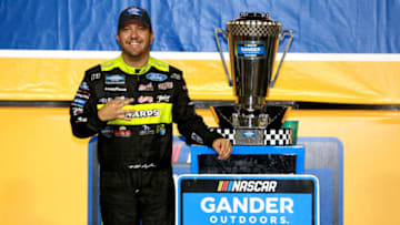 HOMESTEAD, FLORIDA - NOVEMBER 15: Matt Crafton, driver of the #88 Jack Links/Menards Ford, poses with the trophy after winning the NASCAR Gander Outdoors Truck Series Championship at Homestead-Miami Speedway on November 15, 2019 in Homestead, Florida. (Photo by Sean Gardner/Getty Images)