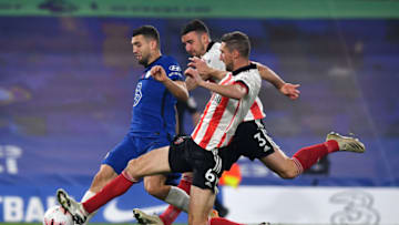 LONDON, ENGLAND - NOVEMBER 07: Mateo Kovacic of Chelsea is challenged by Enda Stevens of Sheffield United and Chris Basham of Sheffield United during the Premier League match between Chelsea and Sheffield United at Stamford Bridge on November 07, 2020 in London, England. Sporting stadiums around the UK remain under strict restrictions due to the Coronavirus Pandemic as Government social distancing laws prohibit fans inside venues resulting in games being played behind closed doors. (Photo by Ben Stansall - Pool/Getty Images)