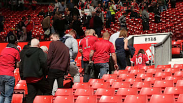 MANCHESTER, ENGLAND - MAY 15: Fans are evacuated from the stands following a security alert and subsequent match abandonment prior to the Barclays Premier League match between Manchester United and AFC Bournemouth at Old Trafford on May 15, 2016 in Manchester, England. (Photo by Matthew Ashton - AMA/Getty Images)