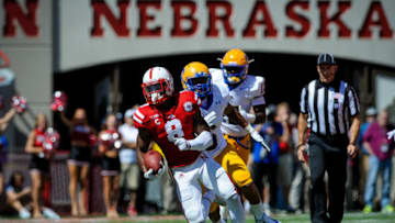LINCOLN, NE - SEPTEMPER 6: Running back Ameer Abdullah #8 of the Nebraska Cornhuskers runs past defensive back Brent Spikes #6 and the McNeese State Cowboys during their game at Memorial Stadium on September 6, 2014 in Lincoln, Nebraska. Abdullah broke off a 58 yard touchdown run with 20 seconds remaining in a tie game. Nebraska defeated McNeese State 31-24. (Photo by Eric Francis/Getty Images)