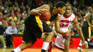 LOUISVILLE, KY - JANUARY 7: Larry O'Bannon #34 of the Louisville basketball program dribbles as Jarekus Singleton #20 of Southern Mississippi defends on January 7, 2004 at Freedom Hall in Louisville, Kentucky. (Photo by Andy Lyons/Getty Images)