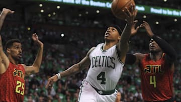 Apr 24, 2016; Boston, MA, USA; Boston Celtics guard Isaiah Thomas (4) lays the ball in the basket past Atlanta Hawks forward Thabo Sefolosha (25) and forward Paul Millsap (4) during the first half in game four of the first round of the NBA Playoffs at TD Garden. Mandatory Credit: Bob DeChiara-USA TODAY Sports