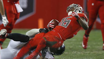 Nov 3, 2016; Tampa, FL, USA; Tampa Bay Buccaneersrunning back Antone Smith (top) hyper extends his knee after being brought down by Atlanta Falcons defensive end Cliff Matthews during the second half of a football game at Raymond James Stadium. Smith left the field on a flatbed cart The Falcons won 43-28. Mandatory Credit: Reinhold Matay-USA TODAY Sports