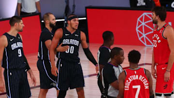 LAKE BUENA VISTA, FLORIDA - AUGUST 05: Aaron Gordon #00 of the Orlando Magic is held back by Evan Fournier (10) after being fouled by Kyle Lowry #7 of the Toronto Raptors in the second half at Visa Athletic Center at ESPN Wide World Of Sports Complex on August 5, 2020 in Lake Buena Vista, Florida. NOTE TO USER: User expressly acknowledges and agrees that, by downloading and or using this photograph, User is consenting to the terms and conditions of the Getty Images License Agreement. (Photo by Kim Klement-Pool/Getty Images)