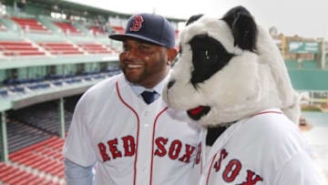 Nov 25, 2014; Boston, Ma, USA; A man in a panda costume greets Boston Red Sox third baseman Pablo Sandoval after the introductory press conference at Fenway Park. Mandatory Credit: Greg M. Cooper-USA TODAY Sports