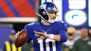 Nov 17, 2013; East Rutherford, NJ, USA; New York Giants quarterback Eli Manning (10) drops back to pass against the Green Bay Packers during the first quarter of a game at MetLife Stadium. Mandatory Credit: Brad Penner-USA TODAY Sports