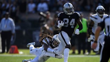 OAKLAND, CA - OCTOBER 15: Cordarrelle Patterson #84 of the Oakland Raiders breaks a tackle on a 47-yard touchdown against the Los Angeles Chargers during their NFL game at Oakland-Alameda County Coliseum on October 15, 2017 in Oakland, California. (Photo by Thearon W. Henderson/Getty Images)