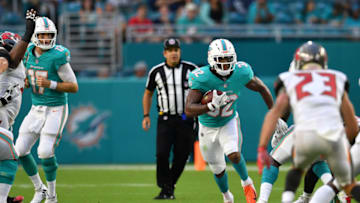 MIAMI, FL - AUGUST 09: Kenyan Drake #32 of the Miami Dolphins runs through the hole in the first quarter during a preseason game against the Tampa Bay Buccaneers at Hard Rock Stadium on August 9, 2018 in Miami, Florida. (Photo by Mark Brown/Getty Images)