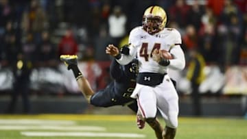 Nov 23, 2013; College Park, MD, USA; Boston College Eagles running back Andre Williams (44) attempts to break free from a diving Maryland Terrapins defensive back Sean Davis (21) during the fourth quarter at Byrd Stadium. Boston College Eagles defeated Maryland Terrapins 29-26. Mandatory Credit: Tommy Gilligan-USA TODAY Sports