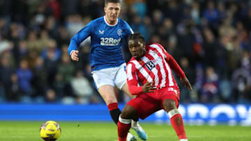 GLASGOW, SCOTLAND - JANUARY 28: Daniel Phillips of St Johnstone passes the ball whilst under pressure from John Lundstram of Rangers during the Cinch Scottish Premiership match between Rangers FC and St. Johnstone FC at Ibrox Stadium on January 28, 2023 in Glasgow, Scotland. (Photo by Ian MacNicol/Getty Images)