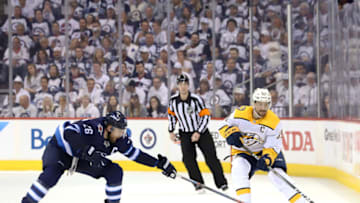 WINNIPEG, MB - MAY 3: Roman Josi #59 of the Nashville Predators chips he puck down the ice past a defending Blake Wheeler #26 of the Winnipeg Jets during third period action in Game Four of the Western Conference Second Round during the 2018 NHL Stanley Cup Playoffs at the Bell MTS Place on May 3, 2018 in Winnipeg, Manitoba, Canada. (Photo by Darcy Finley/NHLI via Getty Images)