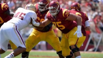 Sep 14, 2013; Los Angeles, CA, USA; USC Trojans guard Marcus Martin (66) and guard Max Tuerk (75) provide protection for quarterback Cody Kessler (6) blocking Boston College Eagles defensive lineman Mehdi Abdesmad (45) during first half action at Los Angeles Memorial Coliseum. The Trojans went on to win 35-7.Mandatory Credit: Robert Hanashiro-USA TODAY Sports