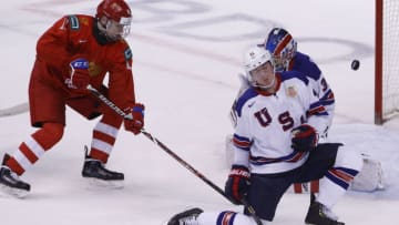 VANCOUVER , BC - JANUARY 4: Dylan Samberg #4 of the United States attempt to block a shot on goaltender Cayden Primeau #30 as Vasili Podkolzin #11 of Russia looks for the puck during a semi-final game at the IIHF World Junior Championships at Rogers Arena on January 4, 2019 in Vancouver, British Columbia, Canada. (Photo by Kevin Light/Getty Images)