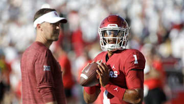 NORMAN, OK - SEPTEMBER 01: Quarterback Jalen Hurts #1 warms up while head coach Lincoln Riley of the Oklahoma Sooners watches before the game against the Houston Cougars at Gaylord Family Oklahoma Memorial Stadium on September 1, 2019 in Norman, Oklahoma. The Sooners defeated the Cougars 49-31. (Photo by Brett Deering/Getty Images)