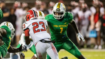 Auburn footballCarver's Jaquavious Russaw (1) sets the edge and tackles Opelika's Kaden Cooper (23) at Cramton Bowl in Montgomery, Ala., on Thursday, Sept. 16, 2021. Opelika leads Carver 14-0 at halftime.