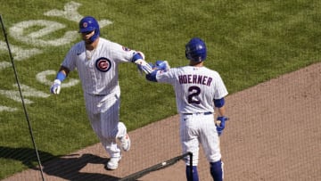 CHICAGO, ILLINOIS - JULY 26: Willson Contreras #40 of the Chicago Cubs is congratulated by Nico Hoerner #2following his home run against the Milwaukee Brewers during the seventh inning of a game at Wrigley Field on July 26, 2020 in Chicago, Illinois. (Photo by Nuccio DiNuzzo/Getty Images)