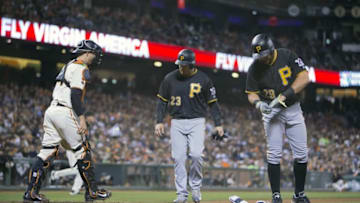 Aug 15, 2016; San Francisco, CA, USA; Pittsburgh Pirates catcher Francisco Cervelli (29) removes his batting gear after being walked with bases loaded in the forth inning walking in Pittsburgh Pirates first baseman David Freese (23) in front of San Francisco Giants catcher Trevor Brown (14) at AT&T Park. Mandatory Credit: Neville E. Guard-USA TODAY Sports