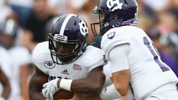 CHESTNUT HILL, MA - SEPTEMBER 08: Quarterback Emmett Clifford #13 of the Holy Cross Crusaders hands off to Domenic Cozier #1 of the Holy Cross Crusaders during the game against the Boston College Eagles at Alumni Stadium on September 8, 2018 in Chestnut Hill, Massachusetts. (Photo by Omar Rawlings/Getty Images)