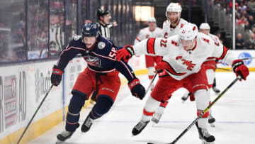 COLUMBUS, OH - JANUARY 16: Eric Robinson #50 of the Columbus Blue Jackets shields the puck from Brett Pesce #22 of the Carolina Hurricanes during the third period of a game on January 16, 2020 at Nationwide Arena in Columbus, Ohio. (Photo by Jamie Sabau/NHLI via Getty Images)
