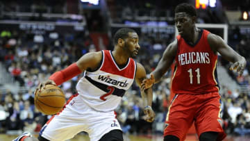 Feb 23, 2016; Washington, DC, USA; Washington Wizards guard John Wall (2) dribbles as New Orleans Pelicans guard Jrue Holiday (11) looks on during the second half at Verizon Center. The Washington Wizards won 109 - 89. Mandatory Credit: Brad Mills-USA TODAY Sports