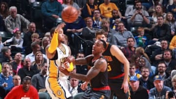 Jan 28, 2016; Indianapolis, IN, USA; Indiana Pacers guard Monta Ellis (11) passes the ball as Atlanta Hawks guard Jeff Teague (0) defends during the first half at Bankers Life Fieldhouse. Mandatory Credit: Brian Spurlock-USA TODAY Sports