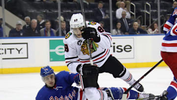 NEW YORK, NEW YORK - JANUARY 17: Brady Skjei #76 of the New York Rangers trips up Patrick Kane #88 of the Chicago Blackhawks during the first period at Madison Square Garden on January 17, 2019 in New York City. (Photo by Bruce Bennett/Getty Images)