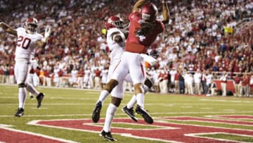 FAYETTEVILLE, AR - OCTOBER 8: Keon Hatcher #4 of the Arkansas Razorbacks catches a touchdown pass over Ronnie Harrison #15 of the Alabama Crimson Tide at Razorback Stadium on October 8, 2016 in Fayetteville, Arkansas. The Crimson Tide defeated the Razorbacks 49-30. (Photo by Wesley Hitt/Getty Images)