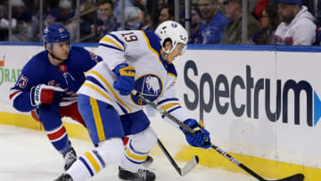Apr 10, 2023; New York, New York, USA; Buffalo Sabres center Peyton Krebs (19) plays the puck against New York Rangers defenseman Adam Fox (23) during the first period at Madison Square Garden. Mandatory Credit: Brad Penner-USA TODAY Sports
