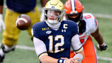 Dec 5, 2020; South Bend, Indiana, USA; Notre Dame Fighting Irish quarterback Ian Book (12) throws in the second quarter against the Syracuse Orange at Notre Dame Stadium. Mandatory Credit: Matt Cashore-USA TODAY Sports