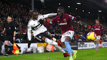 LONDON, ENGLAND - DECEMBER 15: Neeskens Kebano of Fulham crosses the ball under pressure from Arthur Masuaku of West Ham United during the Premier League match between Fulham FC and West Ham United at Craven Cottage on December 15, 2018 in London, United Kingdom. (Photo by Clive Rose/Getty Images)